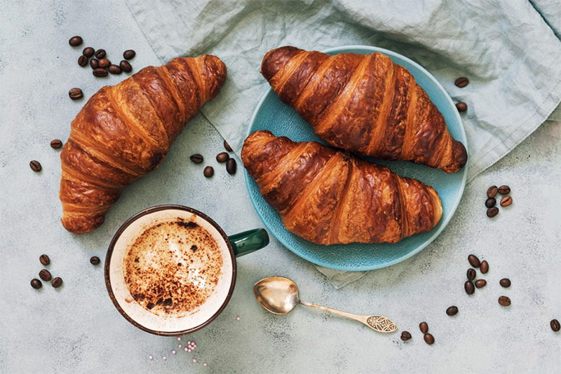 Three Croissant Au Beurre and a cup of café.