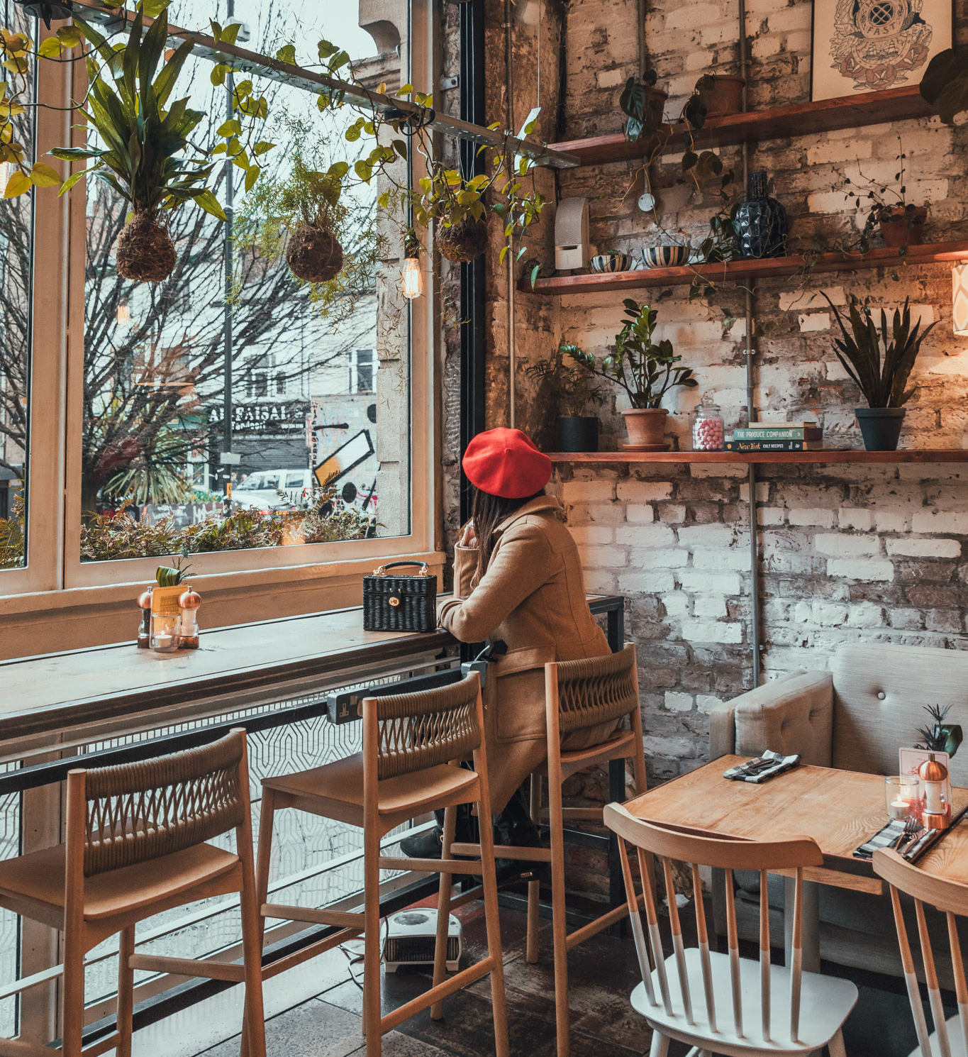 A woman sits inside Poppy's Patisserie.